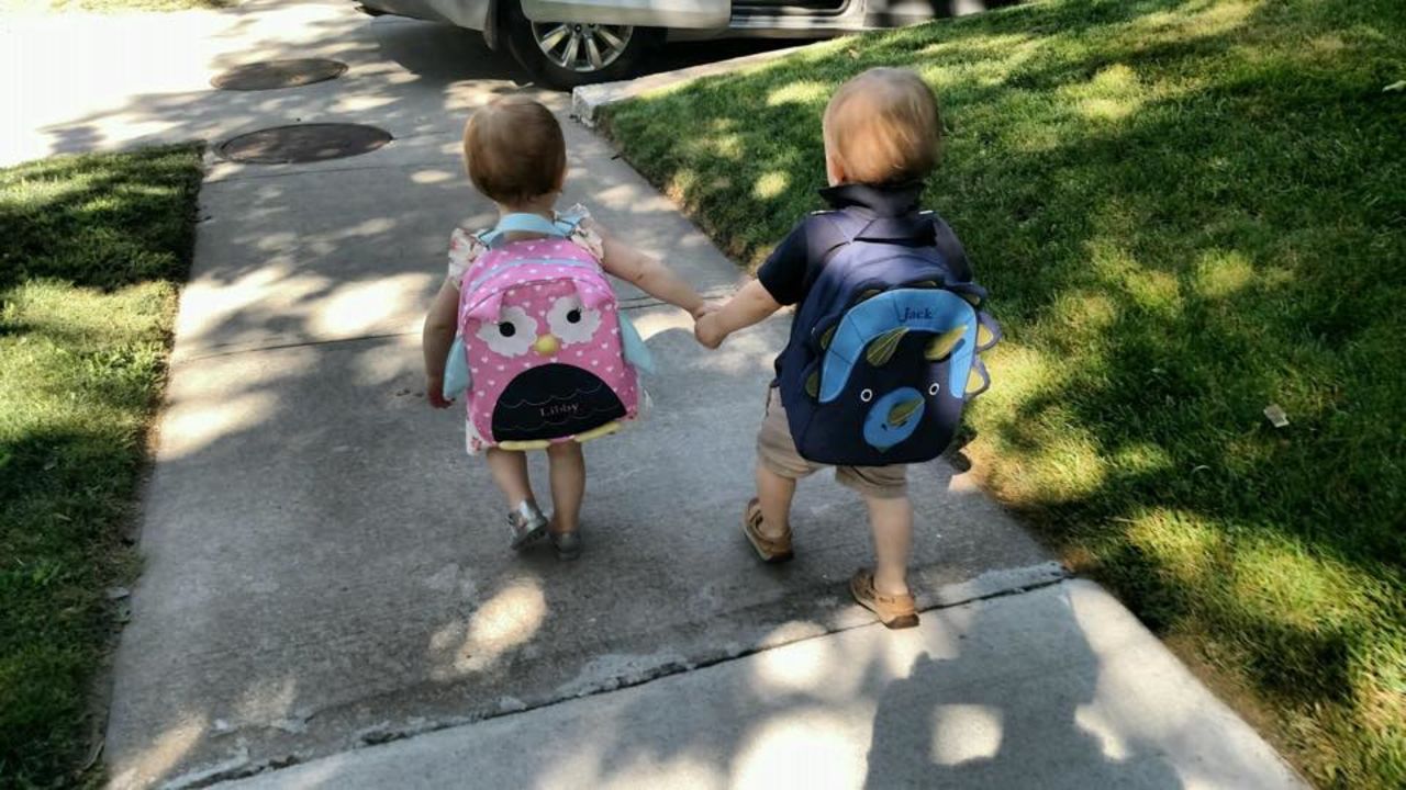 Twin siblings Jack and Libby, 20 months, keep each other close on their first day of school in Brookline, Massachusetts. 