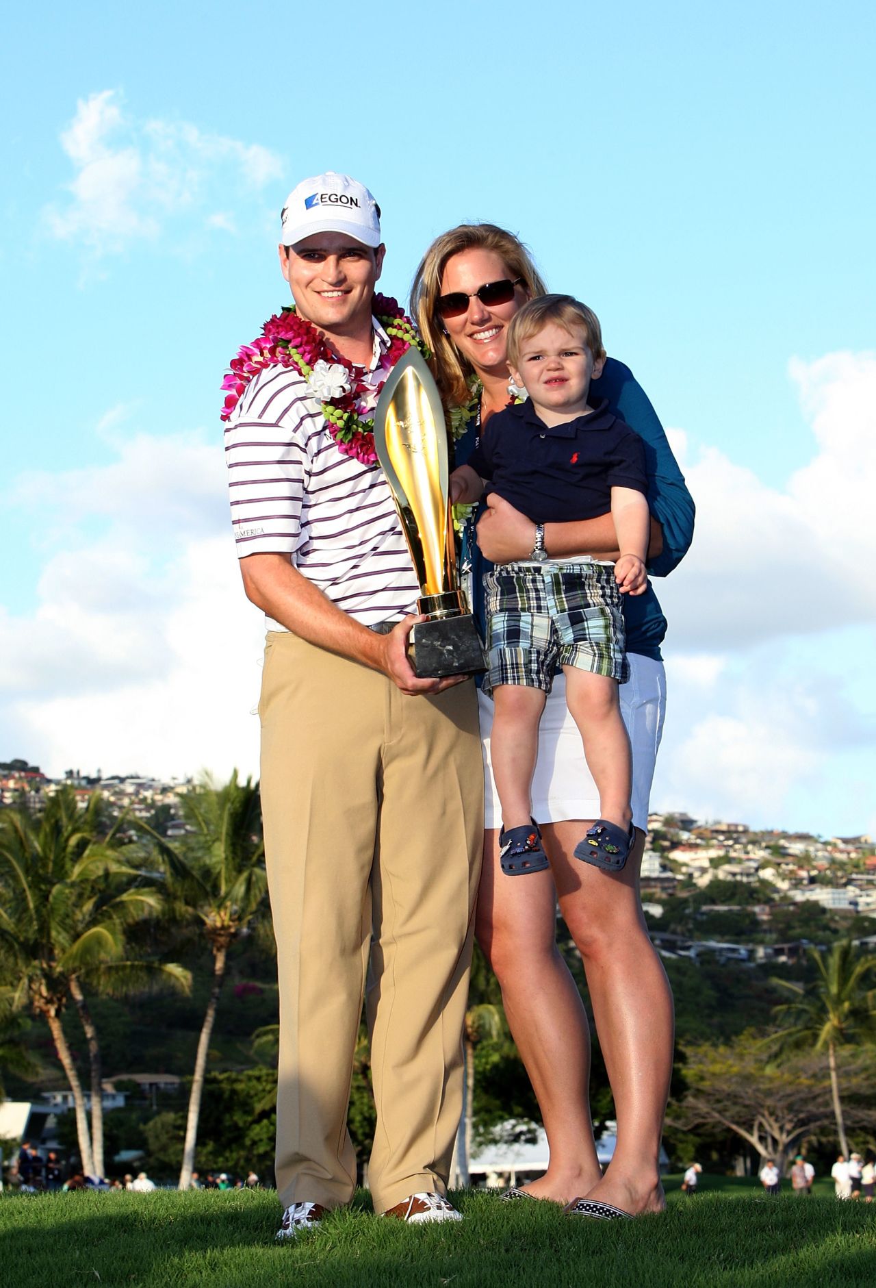 The Johnsons and son Will pose with the trophy after Zach won the PGA Tour's 2009 Sony Open in Hawaii. 