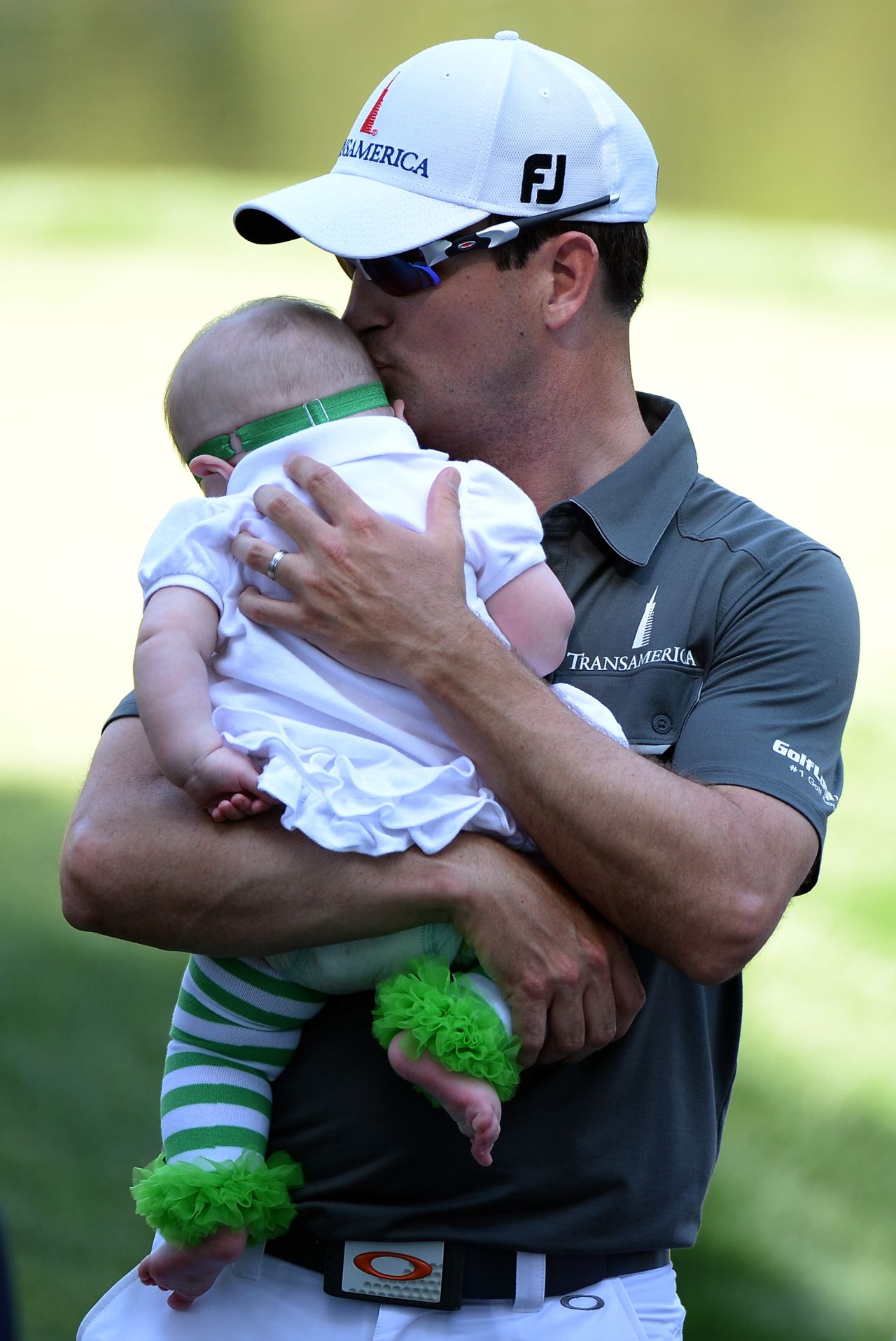 Johnson holds his baby daughter, Abby Jane, during the Par 3 Contest prior to the start of the 2013 Masters Tournament at Augusta.