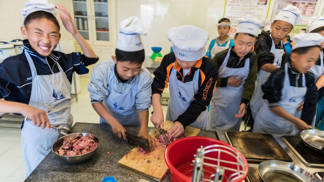 Pan has been shown around schools during his tours. Here he meets a cooking class where students learn about making Korean food.