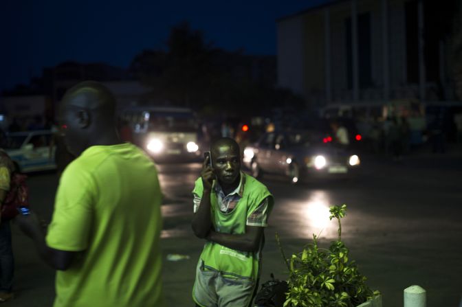 A vendor listens to the news on his cell phone in Bujumbura on Wednesday, July 22. Election results will be announced Friday, with Nkurunziza likely to win a third term. Some opposition groups boycotted the election, and main opposition figure Agathon Rwasa said security forces frustrated his campaign.