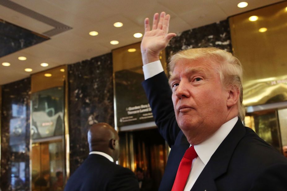 Trump greets onlookers after taping an interview with Anderson Cooper at a Trump-owned building in New York on July 22.