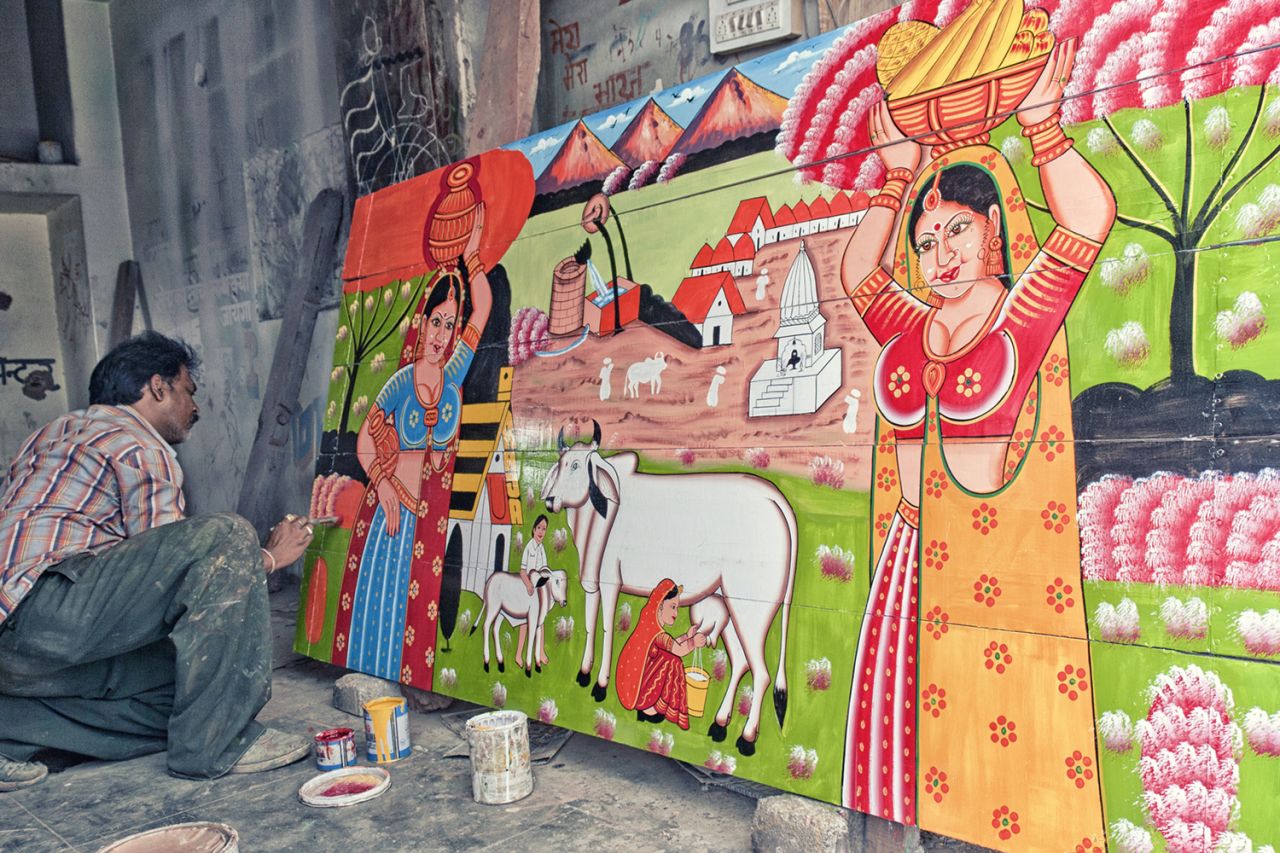 Here, artist Raja Gharu paints the back of a truck.