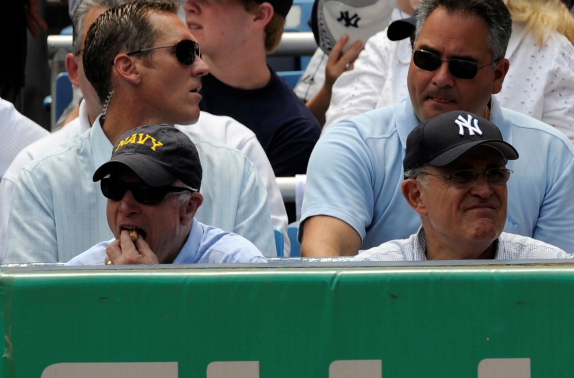 Then-Republican presidential candidate Sen. John McCain of Arizona, left, eats a hot dog with former New York Mayor Rudy Giuliani during a game between the Oakland Athletics and the New York Yankees at Yankee Stadium on July 20, 2008, in the Bronx borough of New York. 