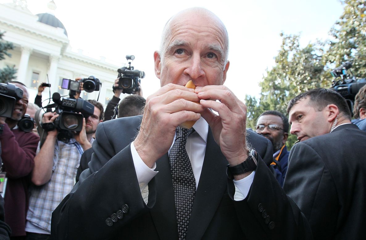 California Gov. Jerry Brown enjoys a hot dog during the People's Party after he was sworn in as the 39th governor of California on January 3, 2011, in Sacramento, California.