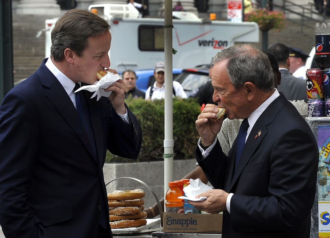 Then-New York Mayor Michael Bloomberg, right, and British Prime Minister David Cameron sample hot dogs outside Penn Station on July 21, 2010.