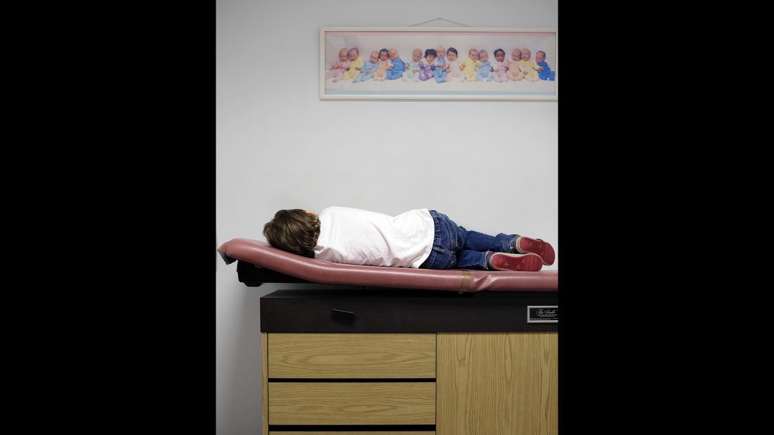 Thomas, suffering from the flu, waits to be seen by his pediatrician in 2014.