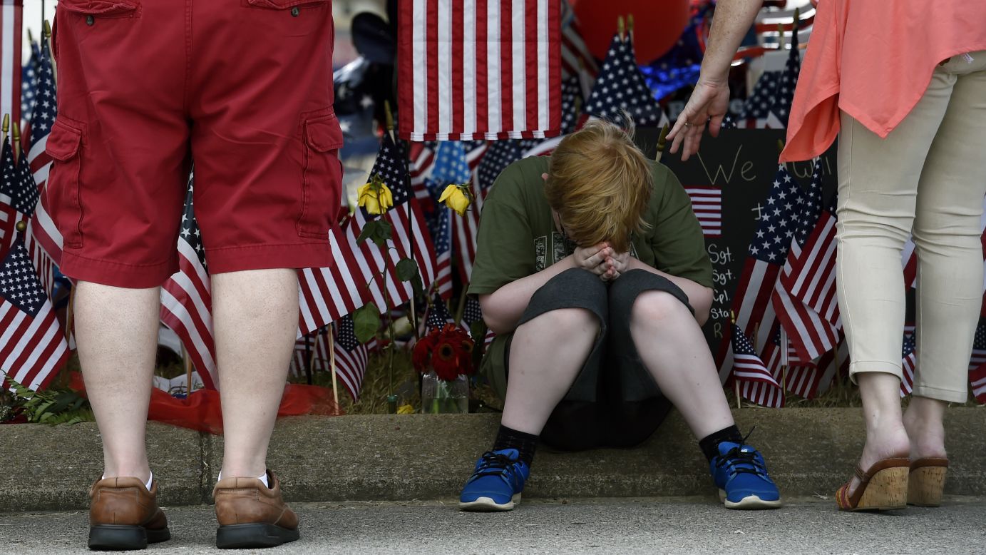 Nicholas Sisk, 10, bows his head at a makeshift memorial outside a military recruiting center in Chattanooga, Tennessee, on Tuesday, July 21. Authorities say Mohammad Youssuf Abdulazeez, 24, <a href="http://www.cnn.com/2015/07/16/us/gallery/chattanooga-tennessee-shooting/index.html" target="_blank">opened fire on the recruiting station</a> on July 16 before moving to a U.S. Navy facility seven miles away. At the Navy facility, Abdulazeez fatally wounded four U.S. Marines and a Navy sailor before being killed in police gunfire.