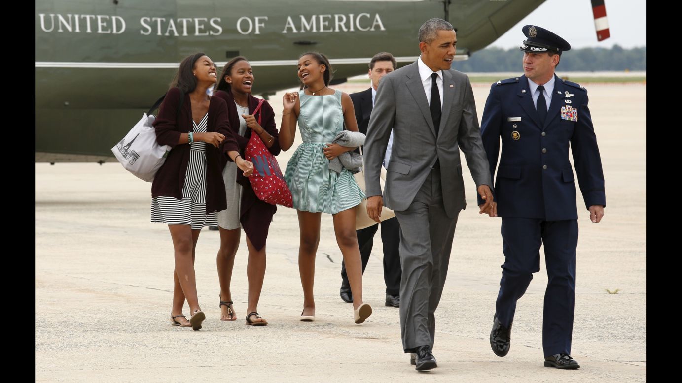U.S. President Barack Obama walks in front of his daughter Sasha, right, and two of her friends as they board Air Force One on Friday, July 17. They were traveling to New York to meet Sasha's sister, Malia, for some father-daughter bonding.