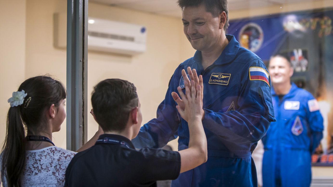 Russian cosmonaut Oleg Kononenko interacts with his children Tuesday, July 21, at the Baikonur cosmodrome in Baikonur, Kazakhstan. Kononenko and his fellow crew members were in quarantine as they prepared for their trip to the International Space Station on Thursday, July 23.