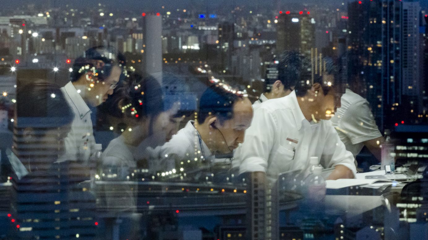 Reporters are reflected in a window overlooking Tokyo as they work at the Toshiba headquarters following a news conference on Tuesday, July 21. Toshiba's chief executive and president <a href="http://money.cnn.com/2015/07/21/investing/toshiba-ceo-resigns/index.html" target="_blank">resigned Tuesday</a> over an accounting scandal that has rocked the company, which makes everything from consumer electronics to nuclear energy technology. Eight board members also resigned as part of a major management reshuffle.