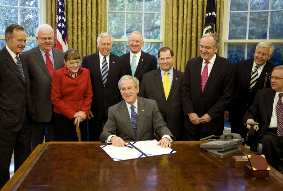 President George W. Bush signs the Americans with Disabilities Amendments Act of 2008. The law built on the ADA by broadening the definition of "disability" to include those with cancer, diabetes and epilepsy. His father, President George H.W. Bush, far left, signed the ADA in 1990.
