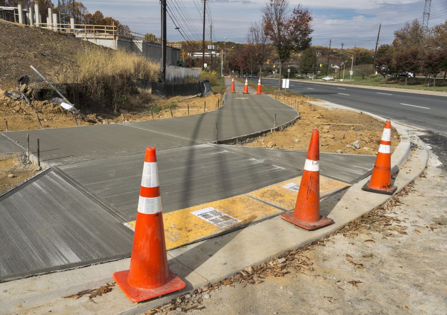 Curb cuts allow equal access to crosswalks, making city travel easier for people in wheelchairs.