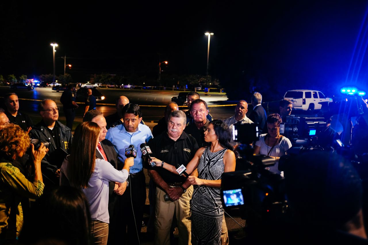 Louisiana Gov. Bobby Jindal, center, speaks with the media near the scene. 