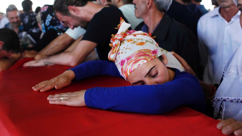 Mourners in Gaziantep, Turkey, grieve over a coffin Tuesday, July 21, during a funeral ceremony for the victims of a suspected ISIS suicide bomb attack. <a href="index.php?page=&url=http%3A%2F%2Fwww.cnn.com%2F2015%2F07%2F20%2Fworld%2Fturkey-suruc-explosion%2F">That bombing killed at least 31 people</a> in Suruc, a Turkish town that borders Syria. Turkish authorities blamed ISIS for the attack.
