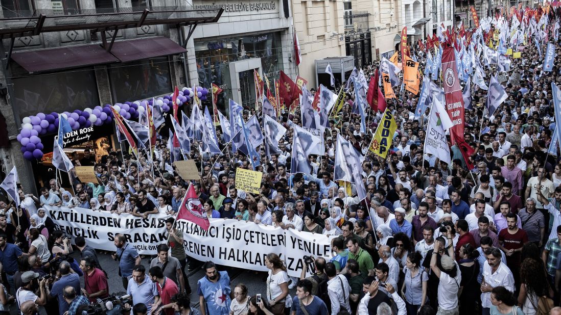 Protesters in Istanbul carry anti-ISIS banners and flags to show support for victims of the Suruc suicide blast during a demonstration on Monday, July 20.