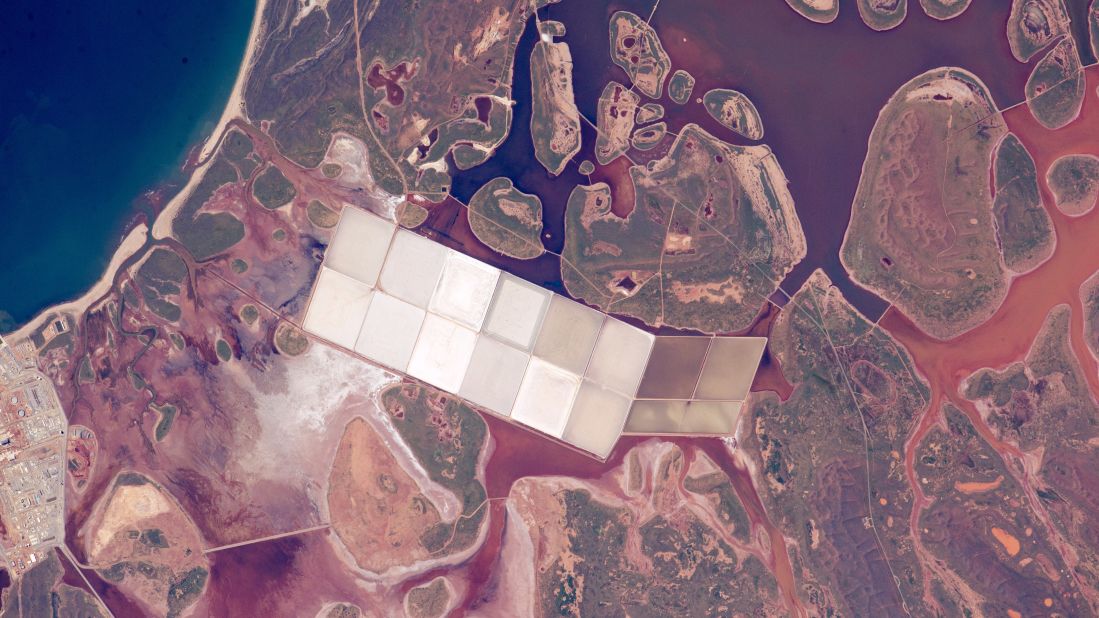 When astronauts look down at Earth from the International Space Station, they use coastlines to help them figure out which part of the planet they're flying over. This photo was taken by a crew member on the space station on June 6. It shows coastal lagoons with rounded islands along the Indian Ocean coastline of Western Australia. You can also see square, white ponds of the salt-extraction industry. This stretch of Australian coast has had more direct hits by cyclones than any other place on the Western Australia's coastline. 