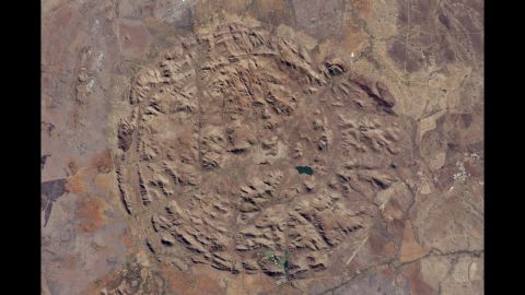 Pilanesberg National Park in North West Province, South Africa, is located in one of the world's largest and best-preserved alkaline ring dike complexes. The circular features were created by an ancient volcano. This image was taken by NASA's Landsat 8 satellite on June 19. Most of the streams that run through the valleys have dried up, but man-made dams have trapped water for the park's wildlife. The structure sits about 300 to 1,600 feet (100 to 500 meters) above the surrounding landscape.