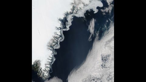Aqua satellite took this image of sea ice on the eastern coast of Greenland on July 16. The swirls of ice are caused by winds and currents that steer the ice, according to NASA.