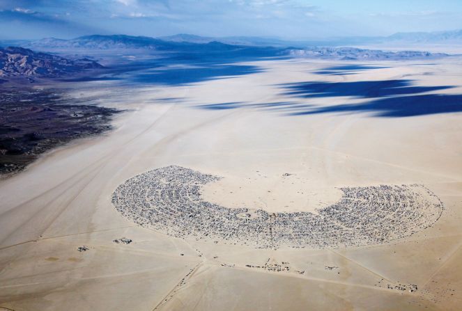 "The two-lane road that winds its way north across the desert isn't any wider today than it was 16 years ago. And this has put a fixed limit on the number of people that can reasonably be accommodated," says Guy. "Black Rock City"  city plan by Rod Garrett (2011) is shown here. 