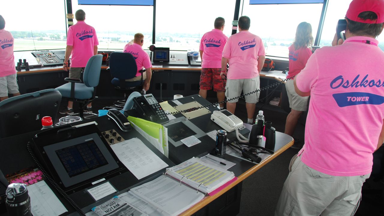 Pink-shirted special air traffic controllers staff the tower at Oshkosh's huge aviation festival this week.  