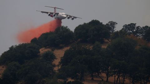 A firefighting aircraft drops retardant on a ridge to combat the Wragg Fire on July 23.