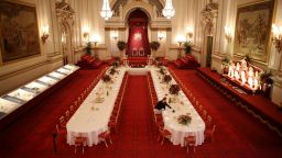 Table settings are laid out in the Palace Ballroom for a State Banquet at The Royal Welcome Summer opening exhibition at Buckingham Palace