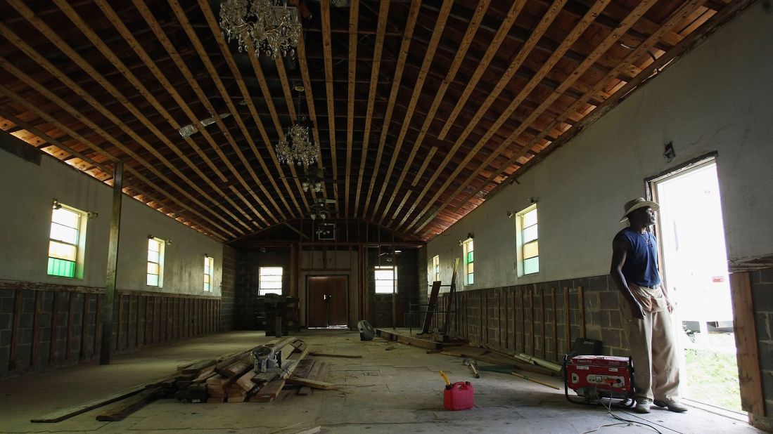 Duette Sims stands in the heavily damaged Christian Community Baptist Church in New Orleans' Lower Ninth Ward on August 28, 2007.