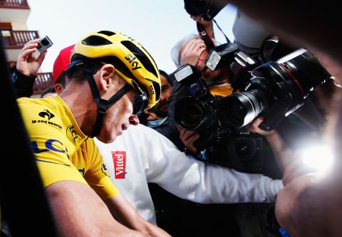 Froome is surrounded by the media after effectively sealing victory by protecting his advantage on the penultimate stage under strong challenge from Quintana.