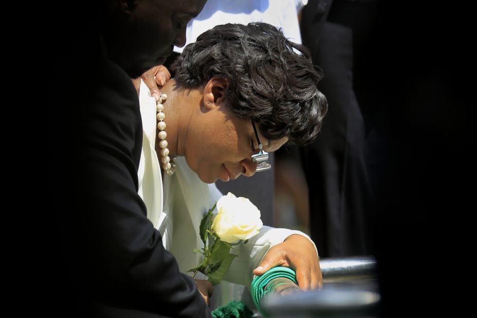 Sandra Bland's sister, Sharon Cooper, kneels at Bland's burial site on July 25. 