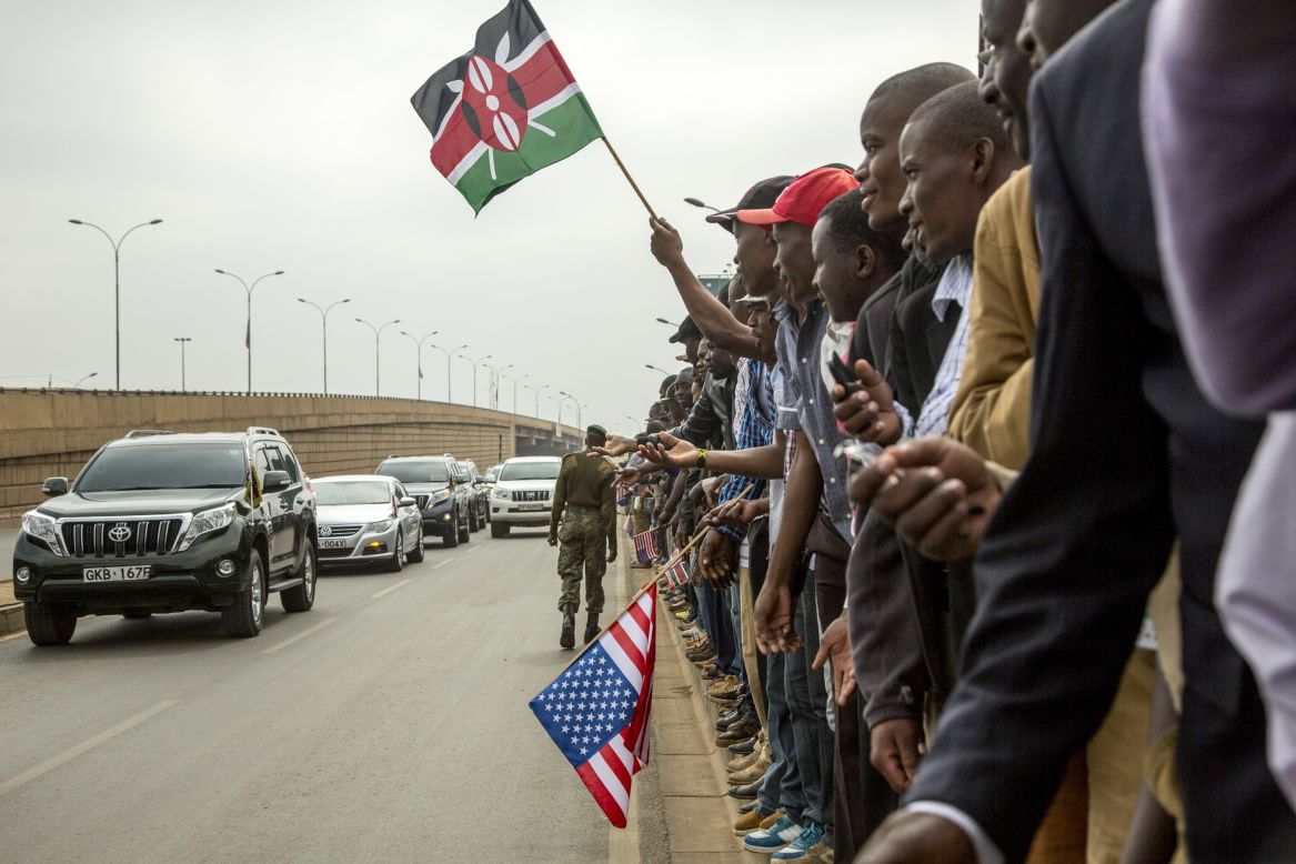 Kenyans wave to members of Kenya's Parliament as they wait for Obama's arrival on July 26.