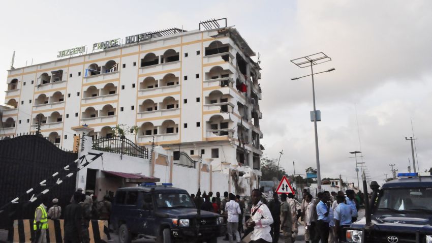 People stand in front of the damaged Jazeera Palace hotel following a suicide attack in Mogadishu on July 26, 2015. Somalia's Shebab insurgents killed at least six people today when they detonated a huge car bomb at a heavily guarded hotel in the capital Mogadishu housing diplomatic missions, officials and witnesses said. AFP PHOTO / STRINGER (Photo credit should read -/AFP/Getty Images)