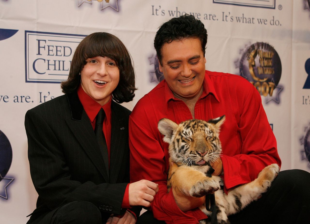 Actor Mitchel Musso (left) poses with Rick Thomas and Chaos the tiger at the 2007 World Magic Awards held at the Barker hanger on October 13, 2007 in Santa Monica, California. 