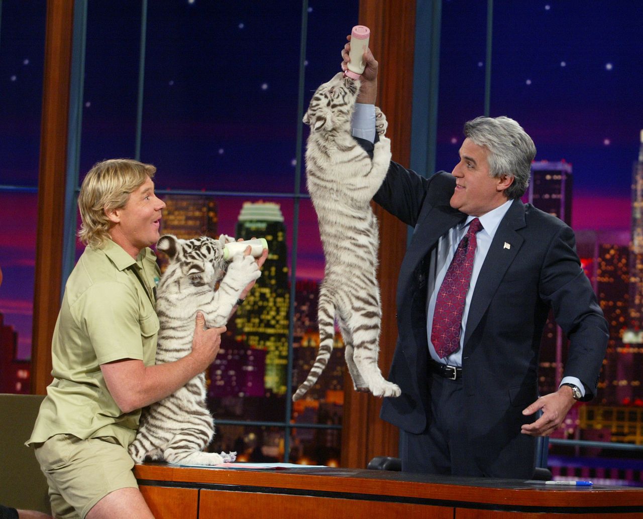 The late Steve Irwin (left), also known as the "Crocodile Hunter," appears with white tiger cubs on "The Tonight Show with Jay Leno" at the NBC studios on February 4, 2003 in Burbank, California. 