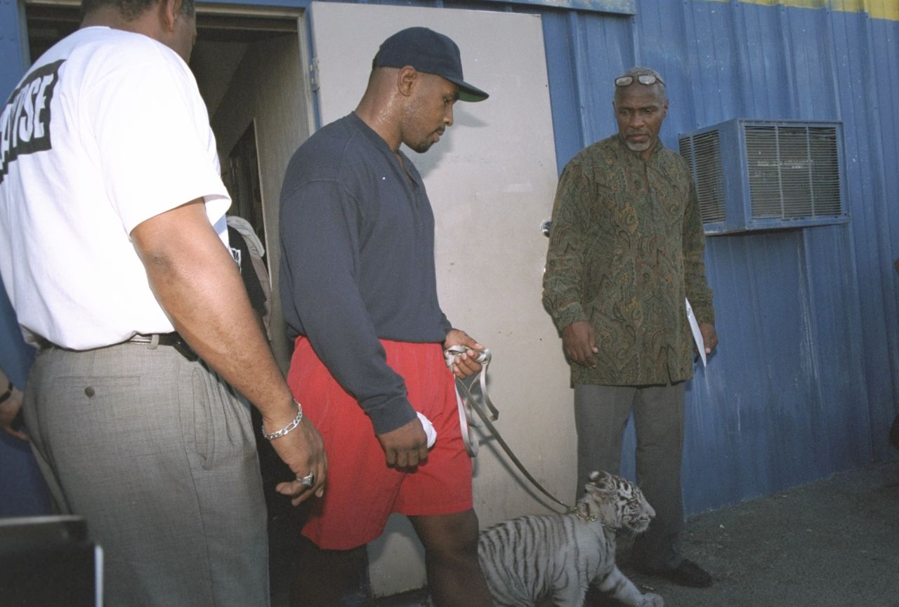 Mike Tyson is accompanied by his pet tiger cub as he enters his workout location in Las Vegas, Nevada in 1995.