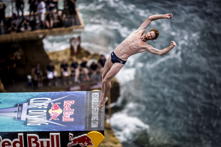 American diver Andy Jones leaps from the 27-meter platform during the fifth stop of the Red Bull Cliff Diving World Series -- featuring professional divers and some of the world's best cliffs -- on the islet of Vila Franca do Campo, Azores, Portugal, on July 18, 2015.