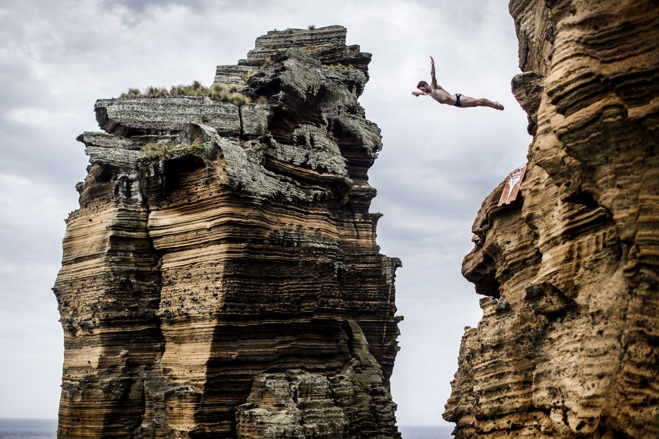 Andy Jones jumps from the 27-meter cliff face near Islet Franca do Campo, Azores, Portugal, on July 18.