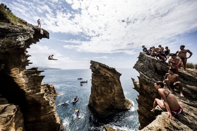 USA's Rachelle Simpson dives from a 20-meter cliff during an open training day of the fifth stop of the Red Bull Cliff Diving World Series, Vila Franca do Campo, Azores, Portugal, on July 15, 2015.