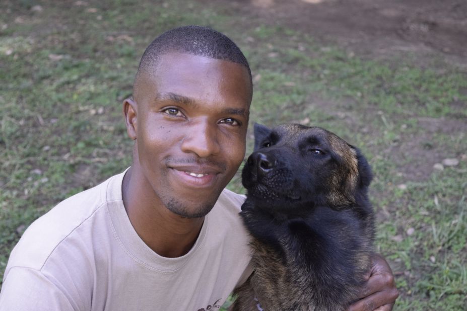 Kenya Wildlife Service ranger-handler William Mariga takes a break with Diva, a female Malinois from Holland. Despite her name, Diva is the most obedient of all the recent dog graduates.