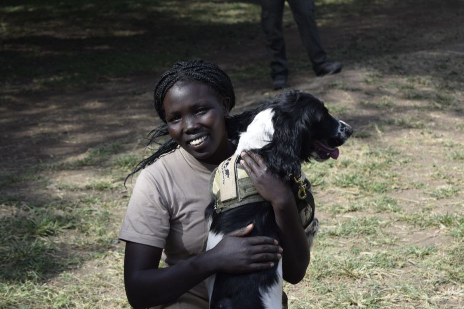 Kenya Wildlife Service ranger Erica Cheruiyot enjoys a playful moment with Asja. Erica and Asja will both be deployed to Mombasa, Kenya, where they will work both the seaport and airport. 