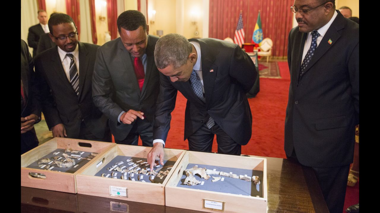 Desalegn, right, watches as Obama touches the "Lucy" exhibit at the National Palace on July 27. "Lucy" is made up of several hundred pieces of bone representing 40% of a female Australopithecus afarensis, a human-like species estimated to have lived in Ethiopia 3.2 million years ago.