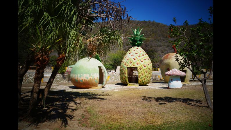A set of fruit-shaped houses at the park.