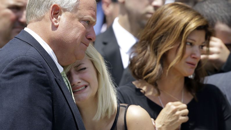 Ali Breaux, center, sister of Mayci Breaux, is comforted outside of the church. 