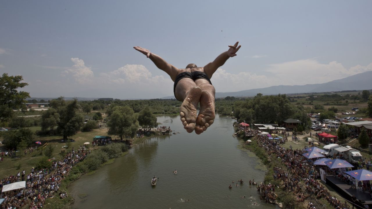 A competitor jumps from the Saint Bridge near Gjakova, Kosovo, during a high-diving competition on Sunday, July 26. 