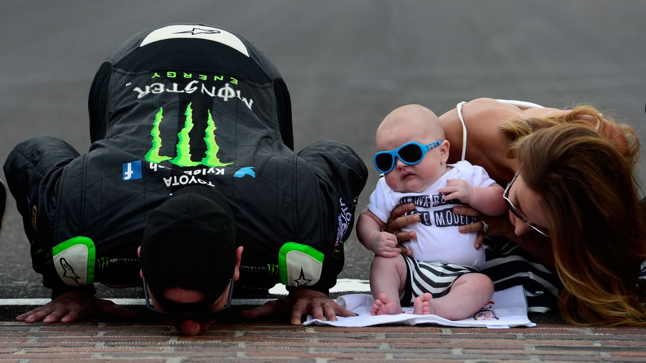 NASCAR driver Kyle Busch kisses the bricks at Indianapolis Motor Speedway after winning the Xfinity Series race there on Saturday, July 25. He was joined by his wife, Samantha, and their son, Brexton. Busch also won the Sprint Cup race on Sunday -- his third Sprint Cup victory in a row.