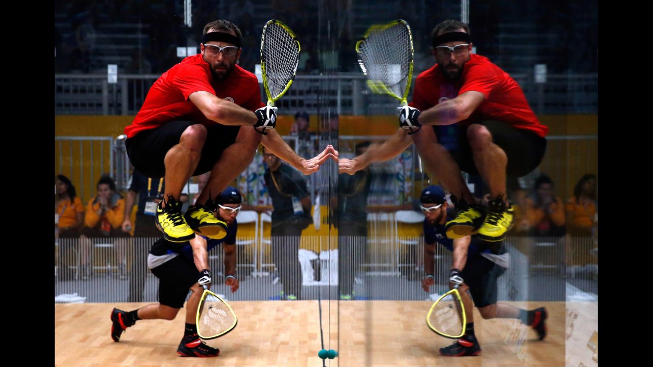Canadian racquetball player Vincent Gagnon jumps out of the way as American Jose Rojas hits the ball during a semifinal match Saturday, July 25, at the Pan American Games in Toronto. The American team won the match but lost to Mexico in the final.