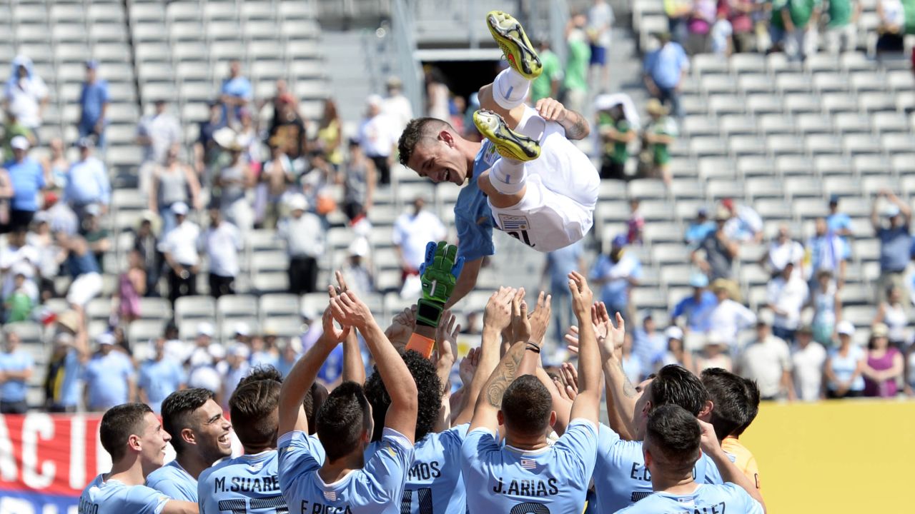Brian Lozano is thrown into the air by his teammates after Uruguay won the gold-medal soccer match at the Pan American Games on Sunday, July 26. Lozano scored the only goal of the match.