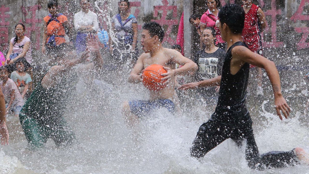 Villagers in Beijing play basketball on a court filled with spring water to celebrate the Xinhe Festival on Thursday, July 23. "Xinhe" means newly planted crops, and the festival is an annual tradition to pray for harvests.