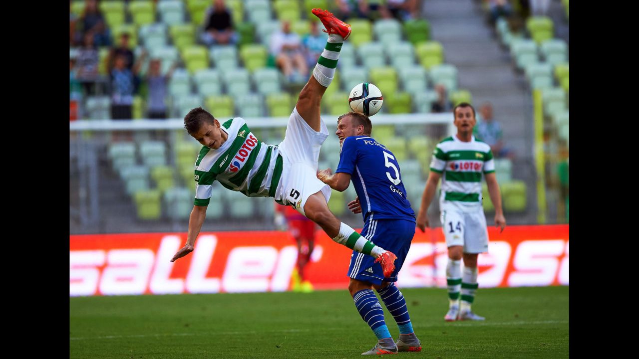 Adam Dzwigala, a defender from Polish soccer club Lechia Gdansk, takes a fall while playing German club Schalke during an exhibition match Wednesday, July 22, in Gdansk, Poland.