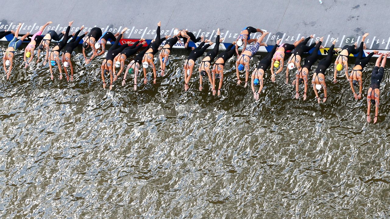 Women dive into the water at the start of the 5-kilometer open-water swimming event held Saturday, July 25, at the World Championships in Kazan, Russia.
